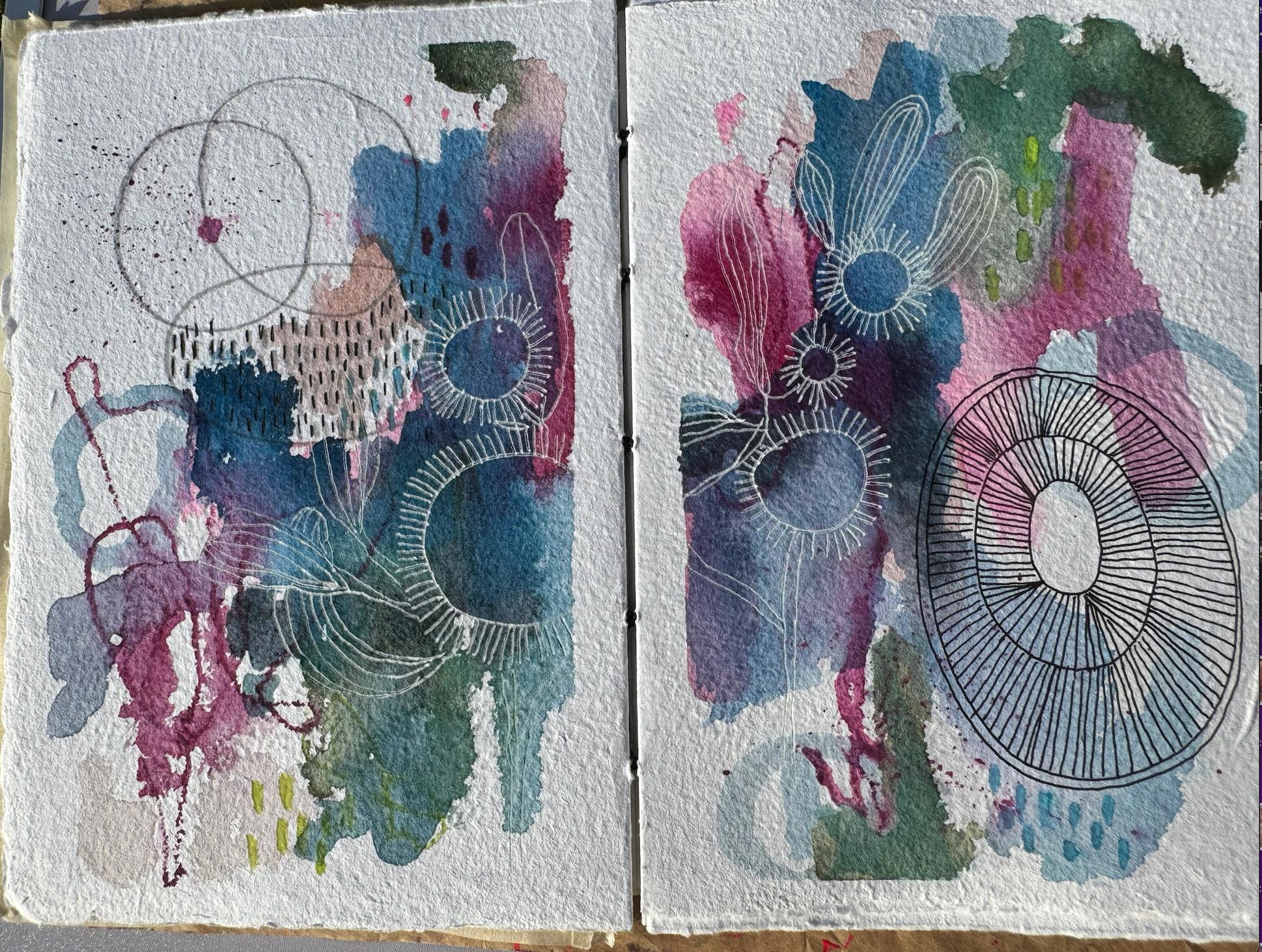 Open art journal spread with soft pink, blue and teal watercolour washes and delicate white flower and circle doodles