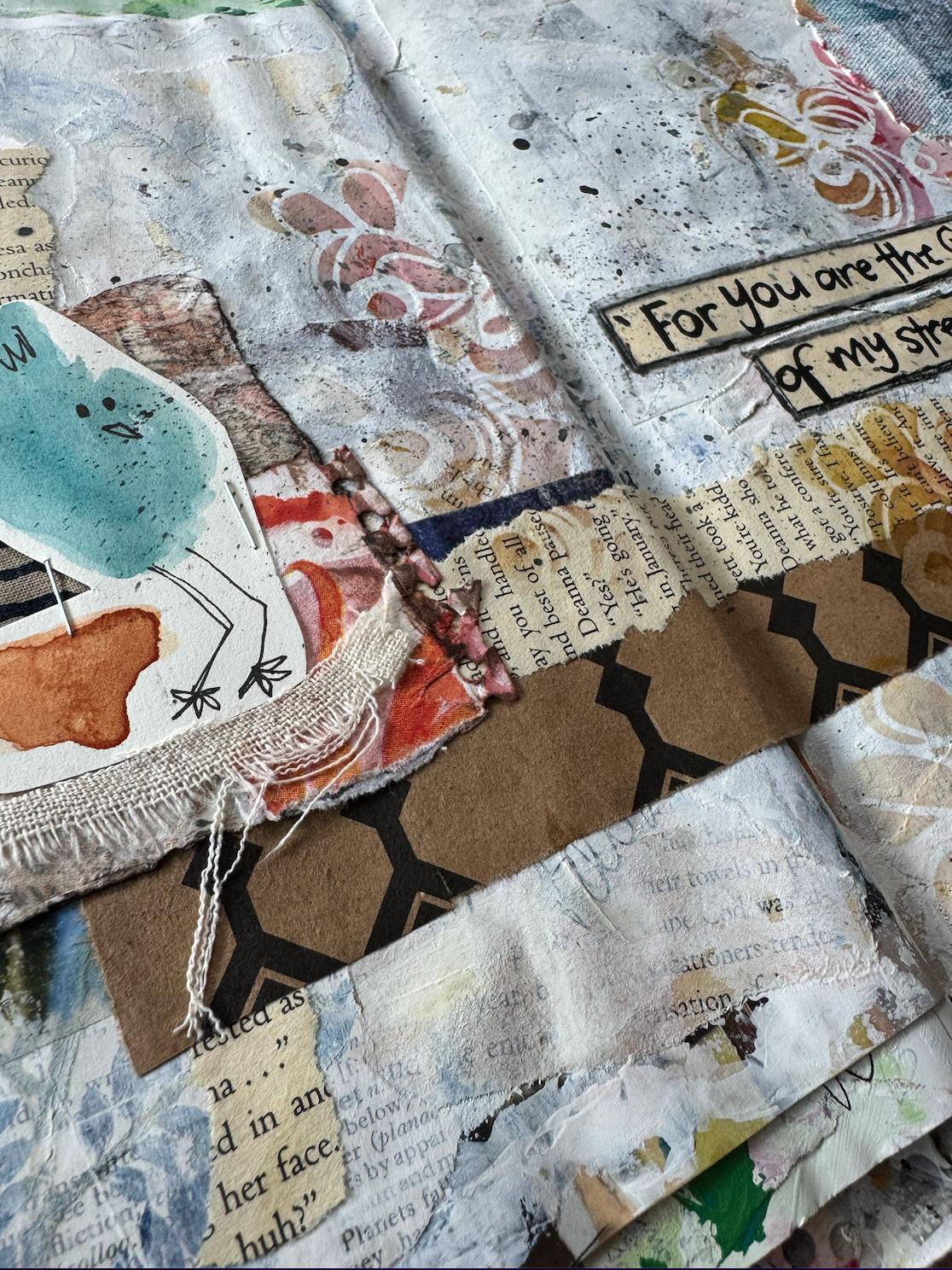 Close-up of a layered junk journal spread with torn pages, fabric strips, paint splatters and a handwritten Scripture strip reading For You are the strength of my strength